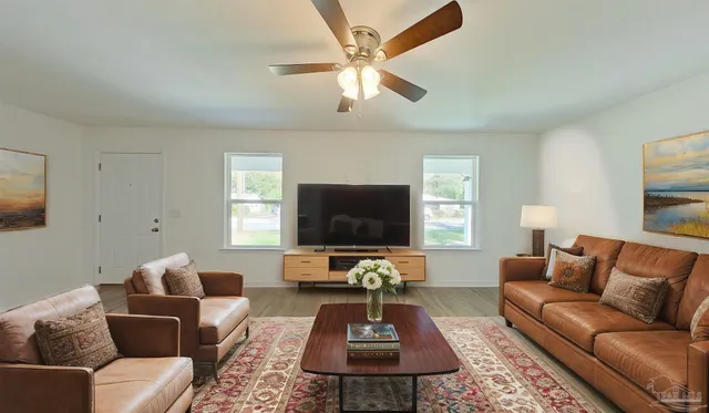 a living room with furniture and a flat screen tv
