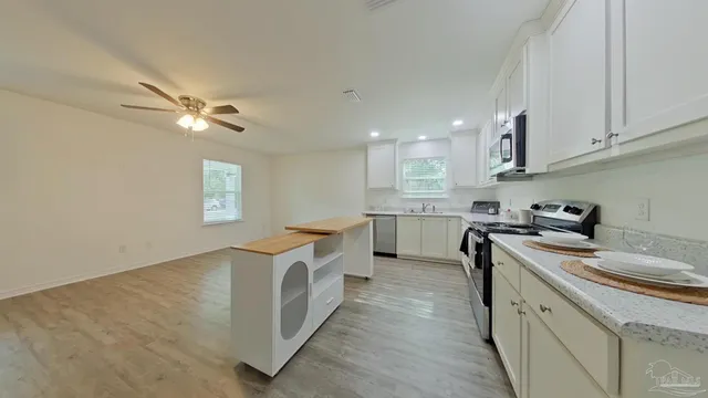 a kitchen with a sink stove and cabinets