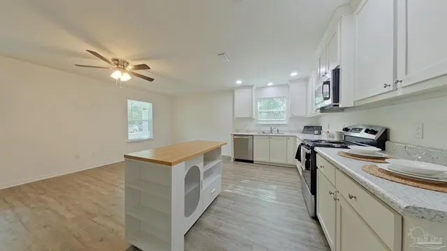 a kitchen with a stove a sink and a refrigerator