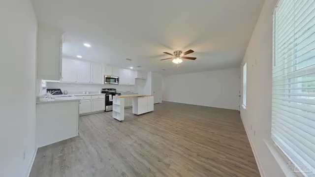 a view of kitchen with sink and refrigerator