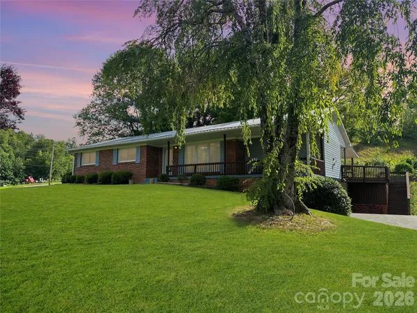 a front view of a house with a garden and yard