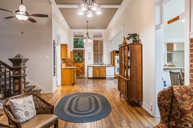 21 North Main Street Kingston, UT 84743 - Photo 83 of 107 Living area featuring ceiling fan, light wood-type flooring, suspended lighting, and a high ceiling