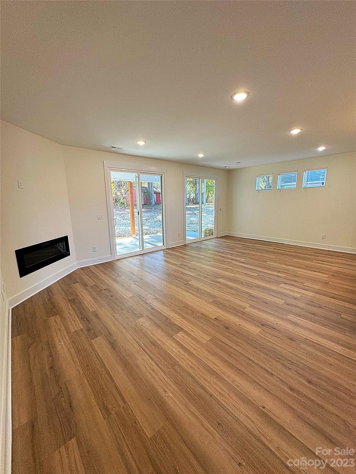 2208 Moose Road Kannapolis, NC 28083 - Photo 3 of 8 an empty room with wooden floor and windows