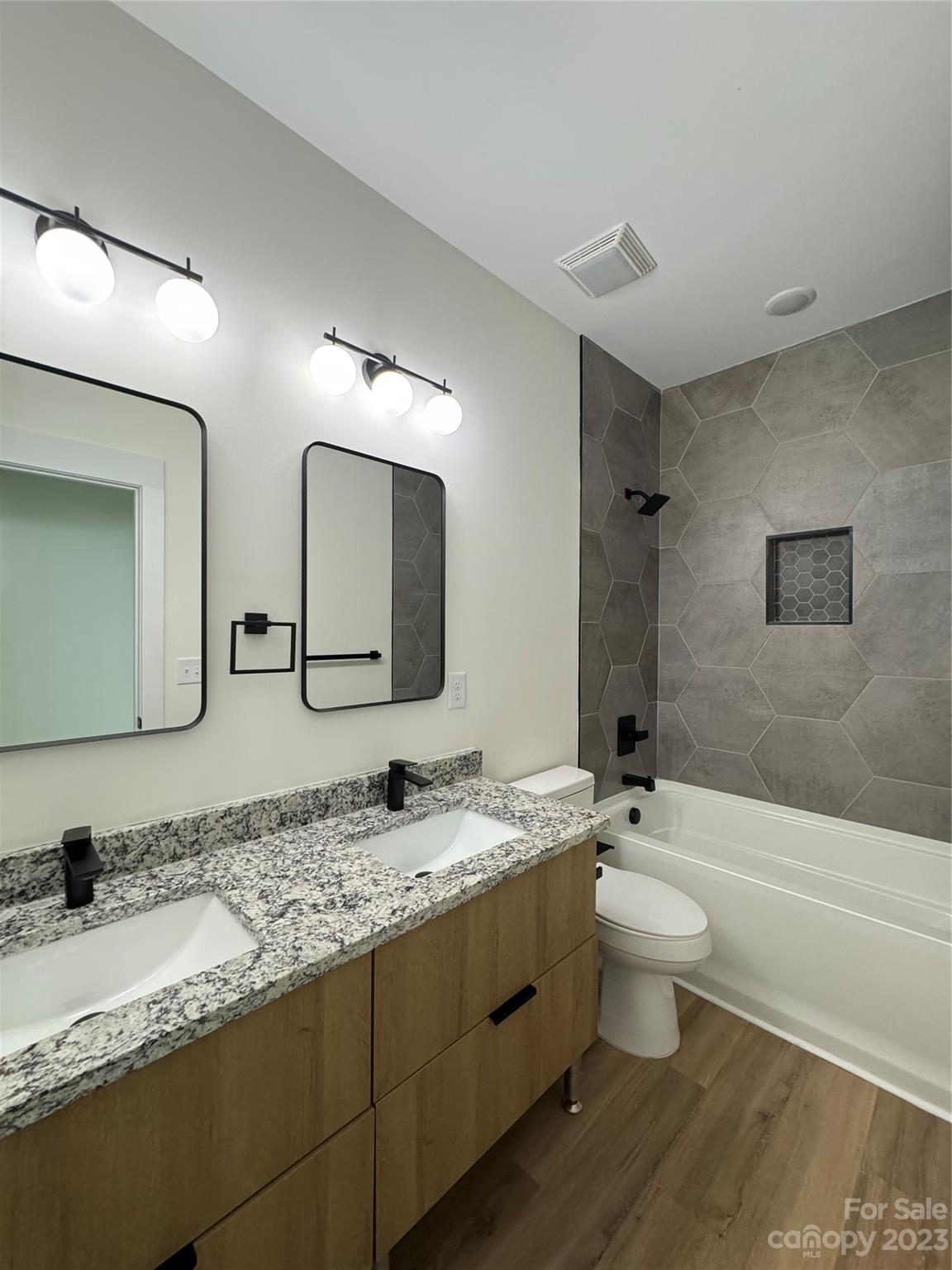 2208 Moose Road Kannapolis, NC 28083 - Photo 4 of 8 a bathroom with a granite countertop toilet sink and mirror