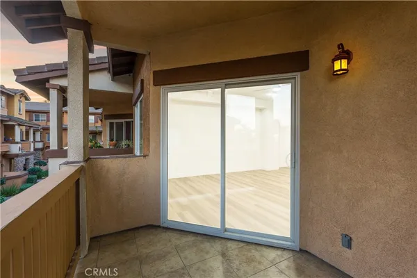 a living room with furniture kitchen view and a window
