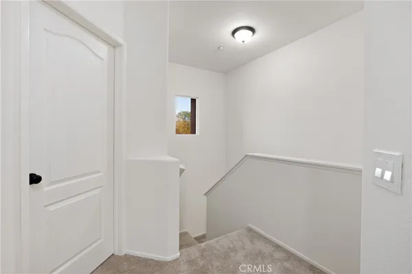 a bedroom with two beds and painting on the wall