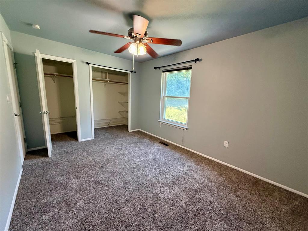 1500 Lake Shore Drive, Unit 402 Waco, TX 76708 - Photo 15 of 18 Primary Bedroom with two closets and beautiful view of green space. behind the condo.