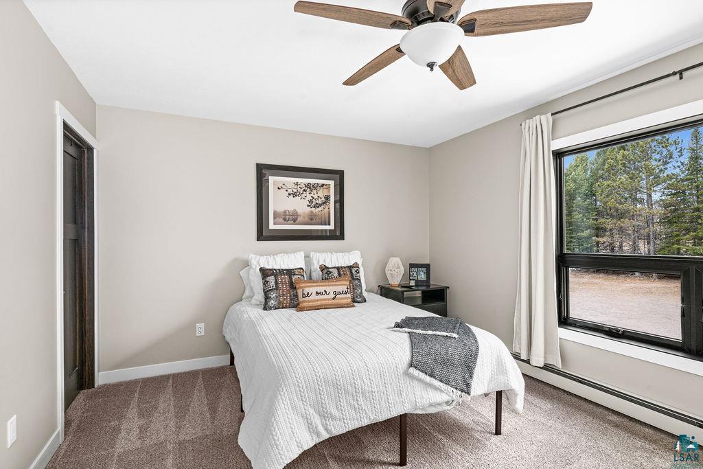 5174 Upper Peterson Road Duluth, MN 55804 - Photo 12 of 42 Carpeted bedroom with baseboard heating and ceiling fan