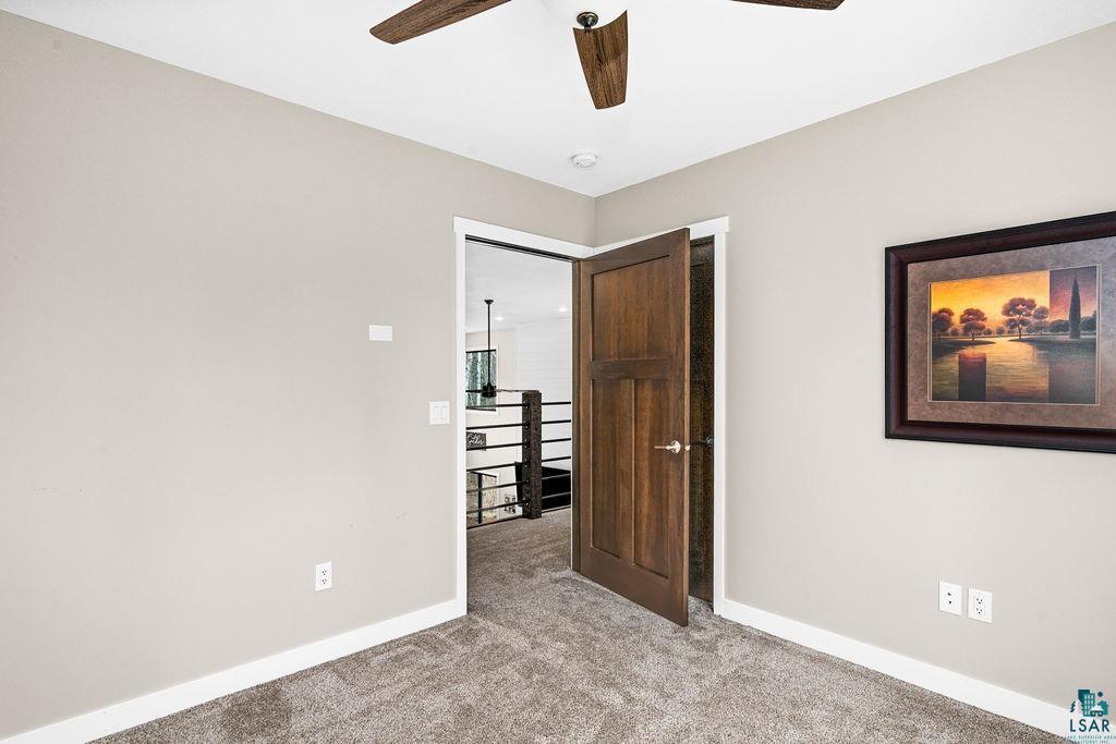 5174 Upper Peterson Road Duluth, MN 55804 - Photo 36 of 42 Unfurnished bedroom featuring light colored carpet and a ceiling fan