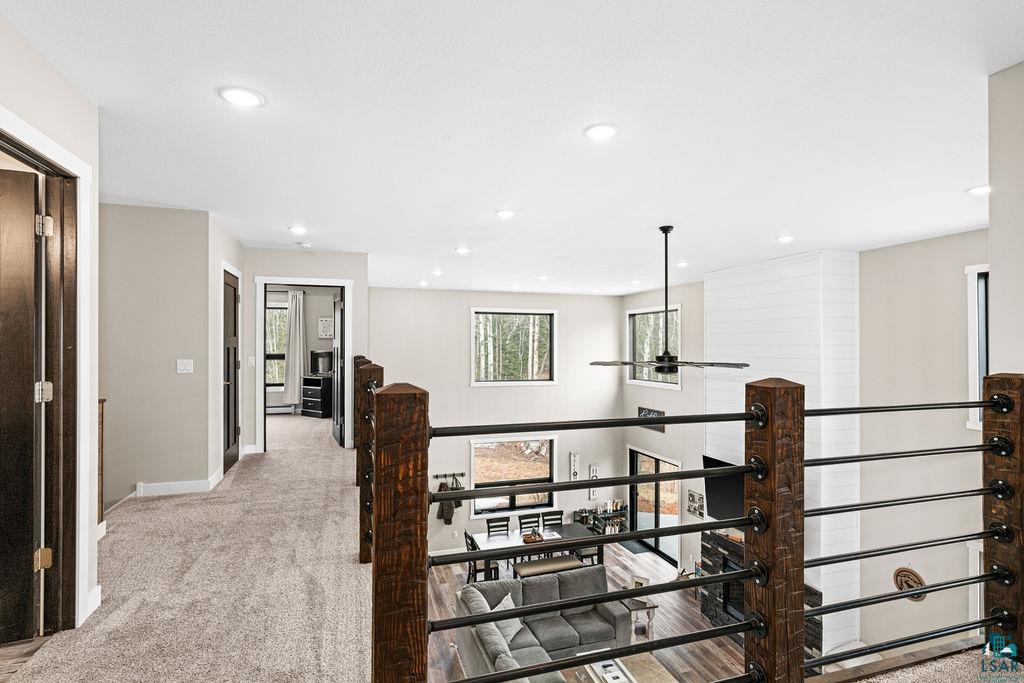 5174 Upper Peterson Road Duluth, MN 55804 - Photo 37 of 42 Hall with an upstairs landing, light colored carpet, and recessed lighting