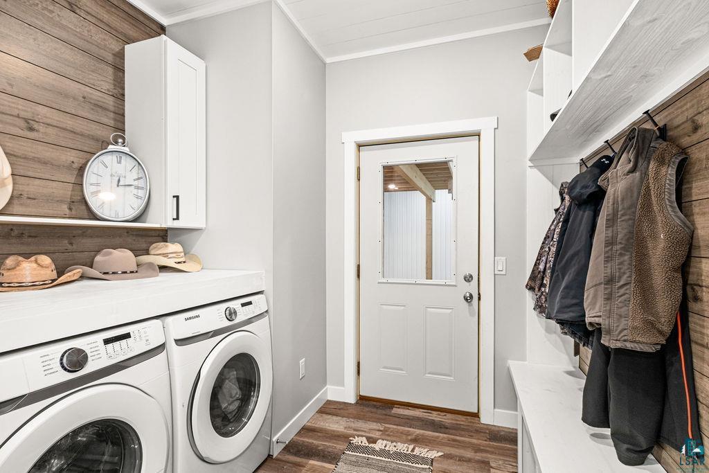 5174 Upper Peterson Road Duluth, MN 55804 - Photo 40 of 42 Laundry area with ornamental molding, dark wood-style floors, washing machine and clothes dryer, and cabinet space
