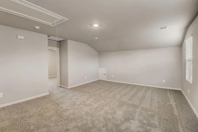 an empty room with a empty space and windows