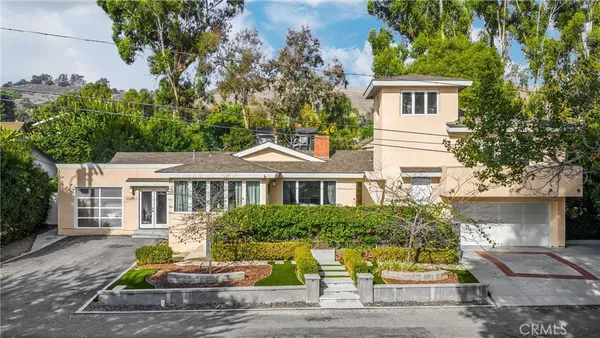 a front view of a house with garden