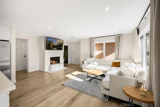 a living room with furniture a fireplace and a table