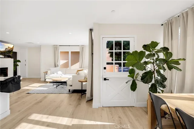 a living room with furniture potted plant and a window