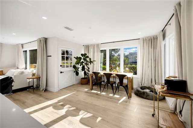 a living room with furniture and large windows