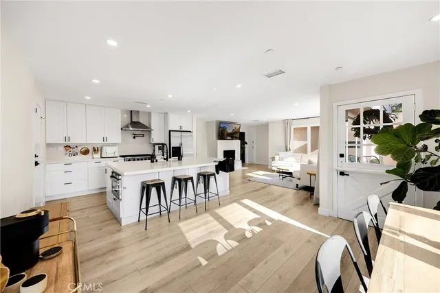 a living room with lots of furniture and kitchen view