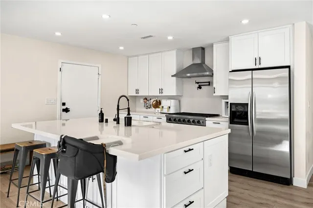 a kitchen with a refrigerator a stove a sink and a microwave