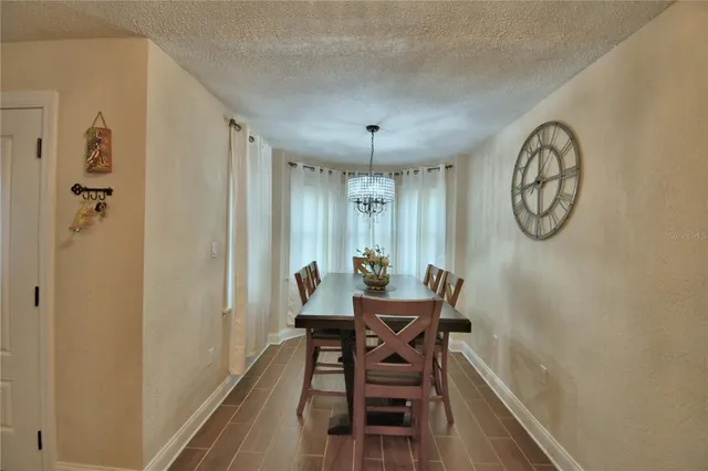 a view of a kitchen with dining area a sink and refrigerator