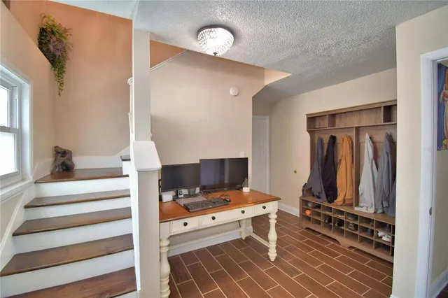 a bedroom with a bed couch and window