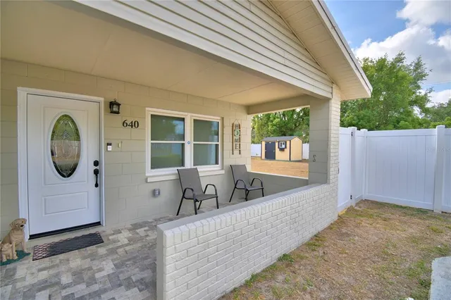 a living room with furniture and a mirror