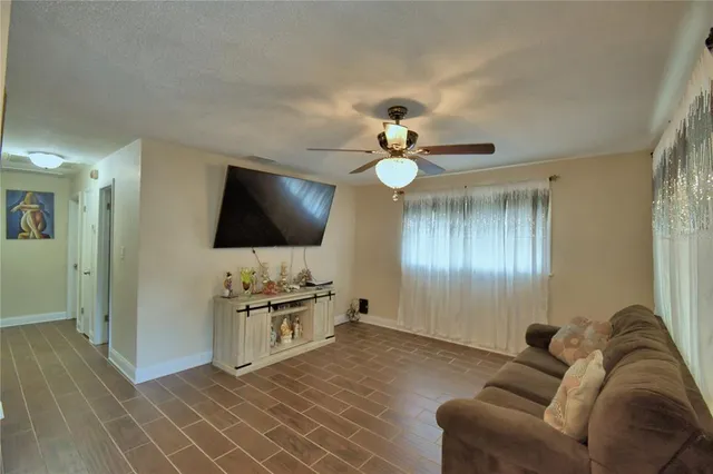 a view of a dining room with furniture and a chandelier