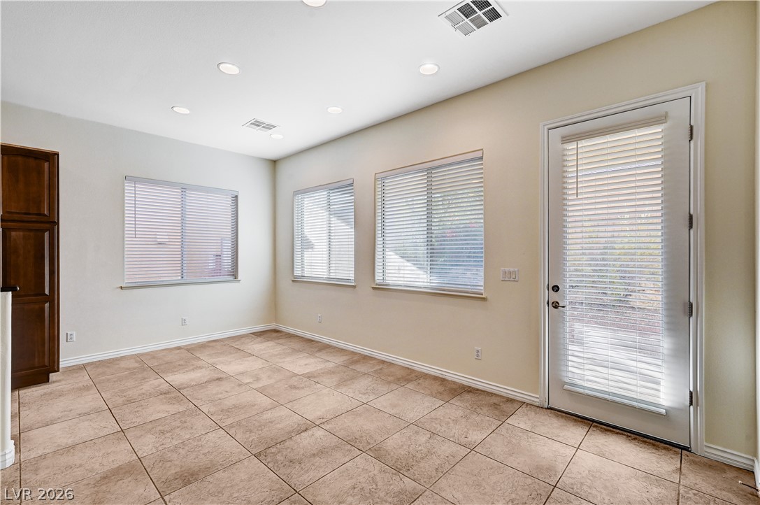 6761 Clay TABLET Street Las Vegas, NV 89149 - Photo 18 of 73 Tiled flooring and recessed lighting define this versatile room with backyard access.