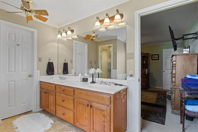 a bedroom with a bed table chair and a window