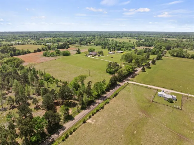 an aerial view of a building with an outdoor space and seating