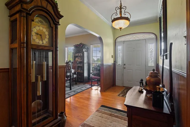 a view of a hallway with livingroom and furniture