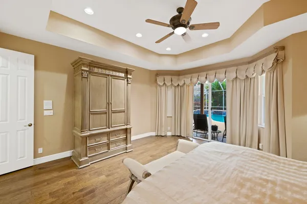 a bedroom with a bed and a ceiling fan