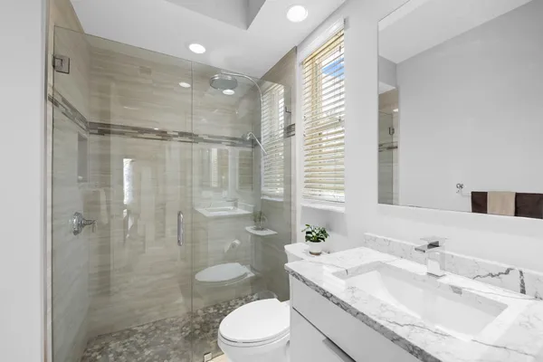 a bathroom with a toilet a sink and shower