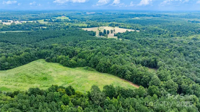 an aerial view of a house with yard and outdoor seating