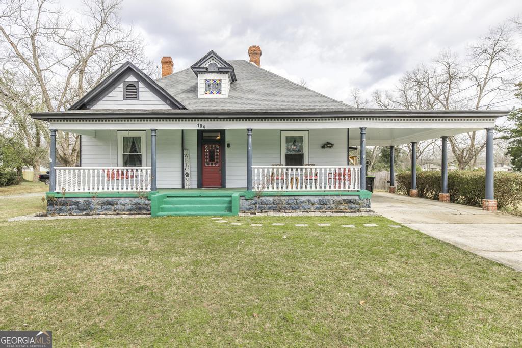 a front view of a house with a garden and yard