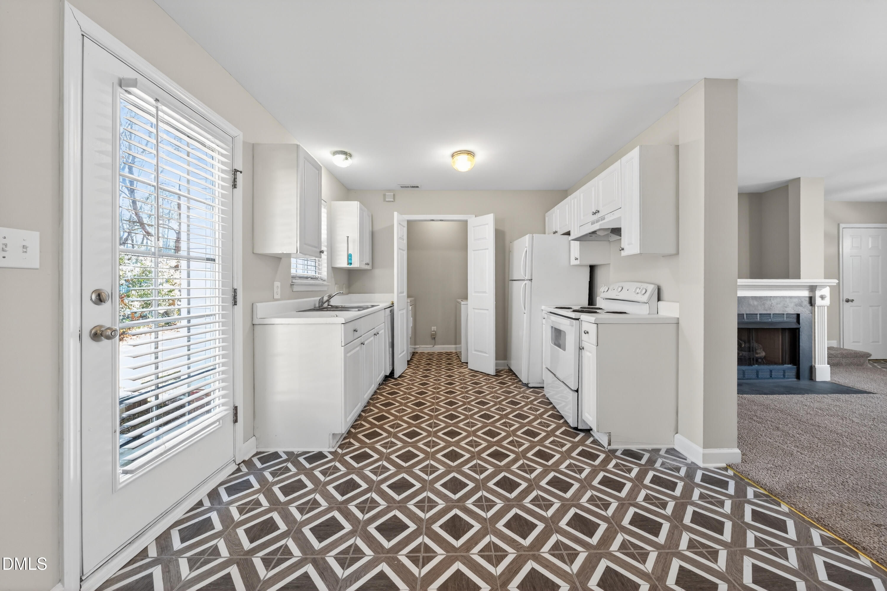 1601 Briarmont Court Raleigh, NC 27610 - Photo 13 of 30 a kitchen with white cabinets and white appliances