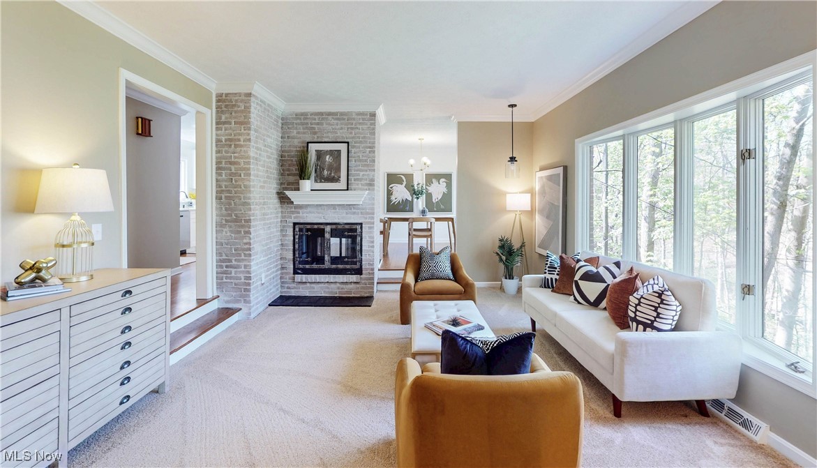 260 Sand Run Road Akron, OH 44313 - Photo 11 of 48 Living room with a fireplace, light colored carpet, visible vents, and ornamental molding