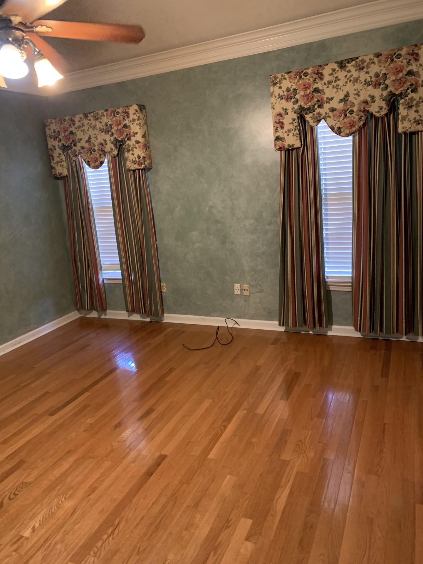 8717 Dexter Road Memphis, TN 38016 - Photo 10 of 12 Large Primary bedroom with wood floors and luxury bath. Large walk-in closet with built in compartments. Double vanity.