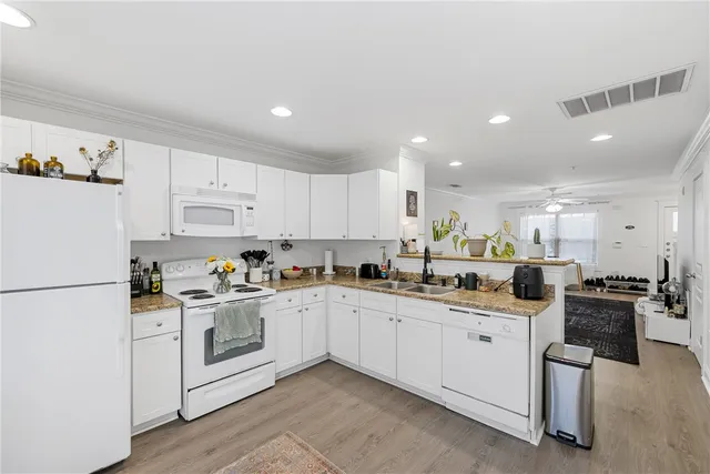 a kitchen with white cabinets sink and white appliances