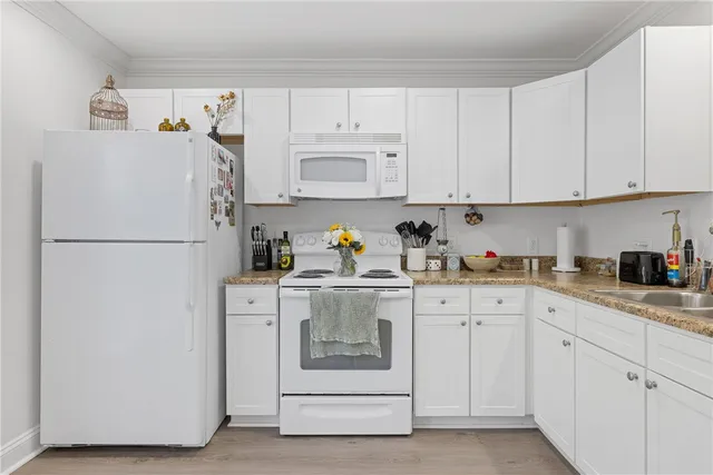a kitchen with cabinets stainless steel appliances and a refrigerator