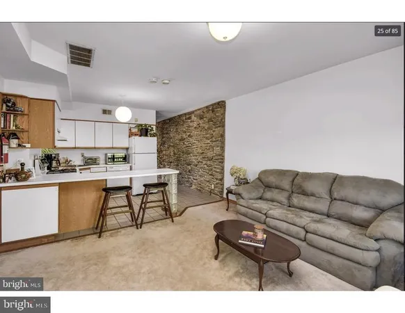 a living room with furniture and kitchen view