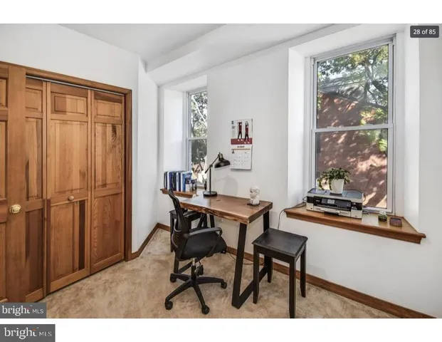 a view of a workspace with furniture and window