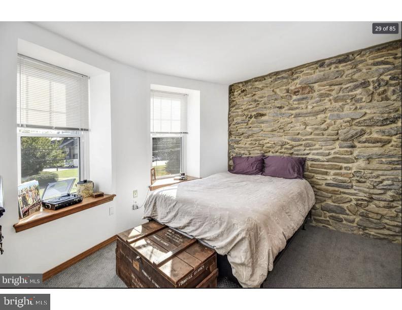 7928 Ridge Avenue Philadelphia, PA 19128 - Photo 15 of 38 a bedroom with a bed and window