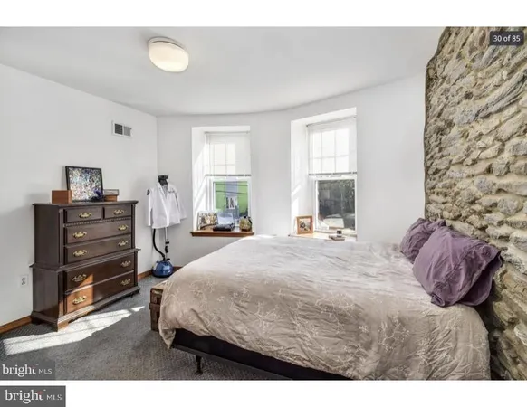 a bedroom with a bed closet and window