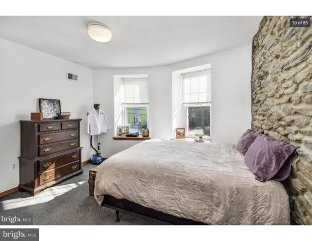 a bedroom with a bed closet and window