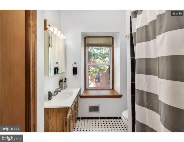 a bathroom with a sink a mirror and a shower