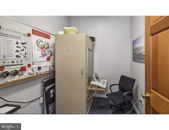 a kitchen with a refrigerator and cabinets