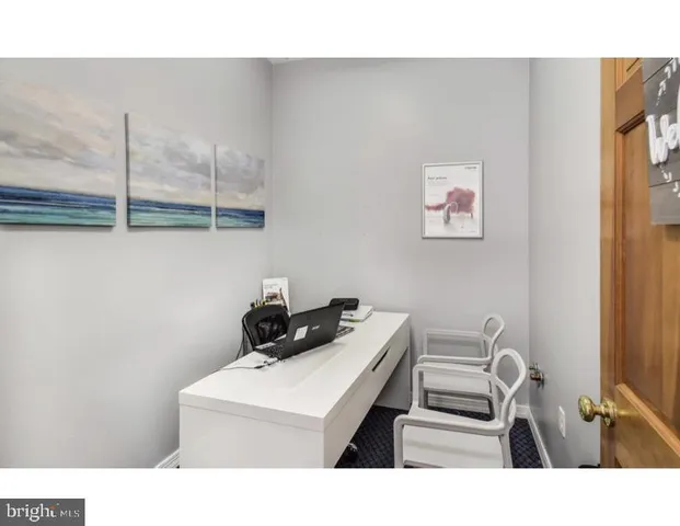 a bathroom with a sink a rug and a chair