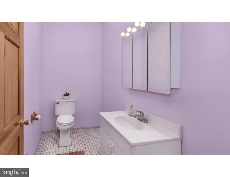 7928 Ridge Avenue Philadelphia, PA 19128 - Photo 21 of 38 a bathroom with a sink toilet a mirror and vanity