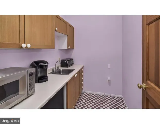 a kitchen with a sink cabinets and appliances