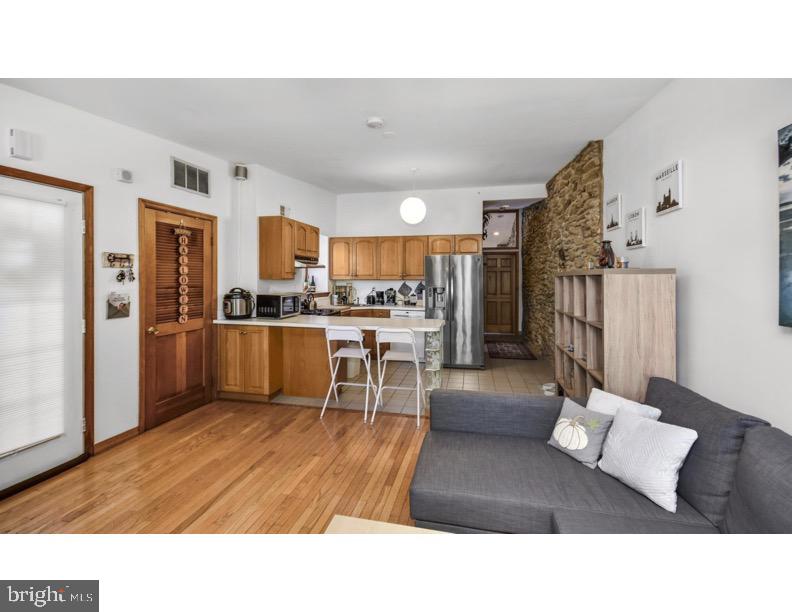 7928 Ridge Avenue Philadelphia, PA 19128 - Photo 23 of 38 a living room with stainless steel appliances kitchen island granite countertop a refrigerator and a sink